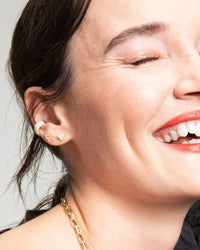 model wearing the Adina Reyter Diamond Puffy Heart Posts with an assortment of other earrings