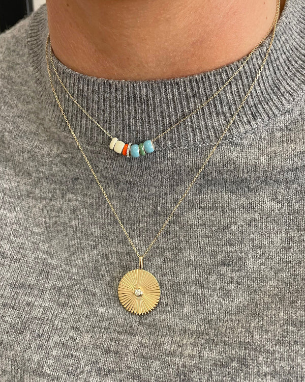 Model wearing the Adina Reyter Reef Party Bead Party Necklace with another AD necklace and a grey sweater