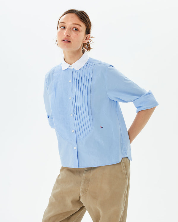 Zoe with her hands on her hips in the French Blue Anette Tuxedo Shirt and tan pants