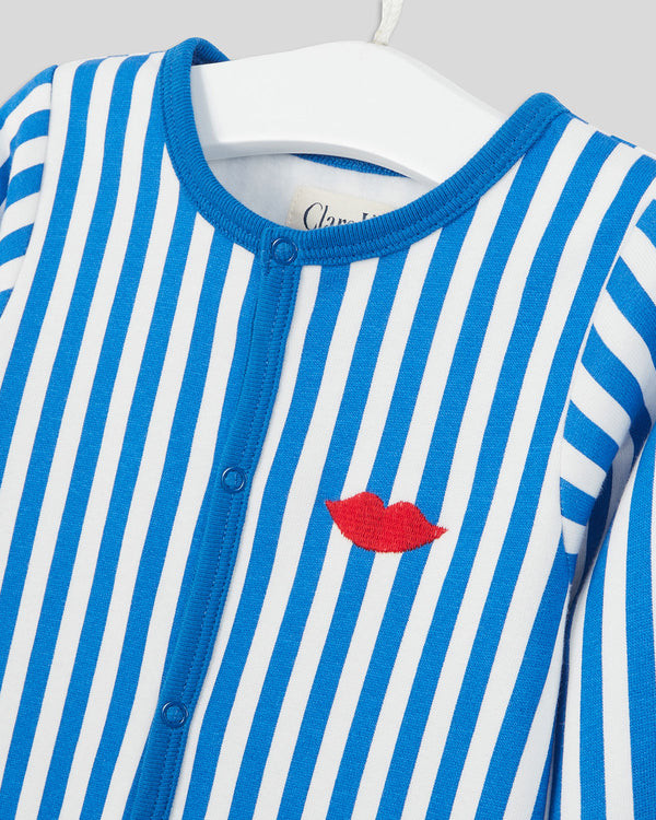 close up of the lips embroidery on the breast of the Baby Footie PJs in Blue and Cream Stripe