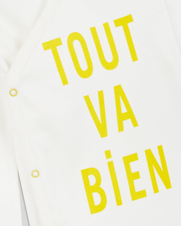 close up of the print and the side snaps on the Cream w/ Marigold Tout va Bien Baby Onesie