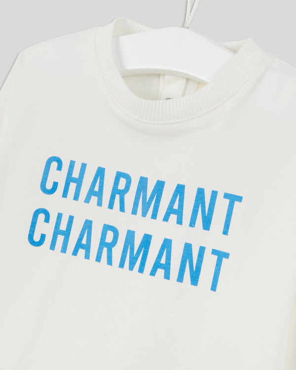 close up of the print on the Baby Longsleeve Tee in Cream with Cobalt Charmant