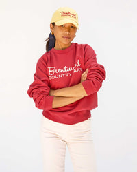 Maly wearing the Butter w/ Brentwood Red BCM Baseball Hat with the Brentwood sweatshirt with white pants
