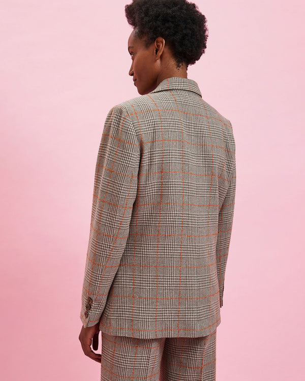 back view of the model wearing the Grey Plaid w/ Orange Stitch Blazer with the matching pants