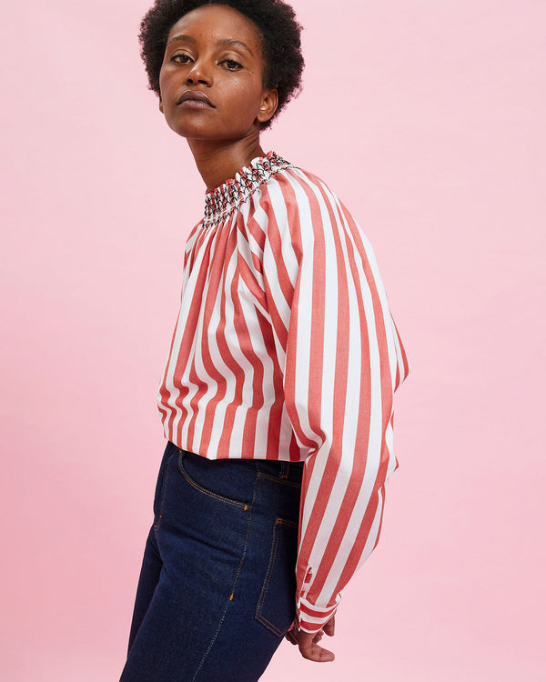 Model wearing the Poppy & Cream Stripes Blouse with blue jeans