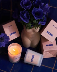 Roen Candle in Bar Monti next to the candle box. one candle is lit