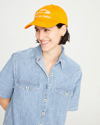 athena wearing the Marigold Liberez les Sardines Baseball Hat