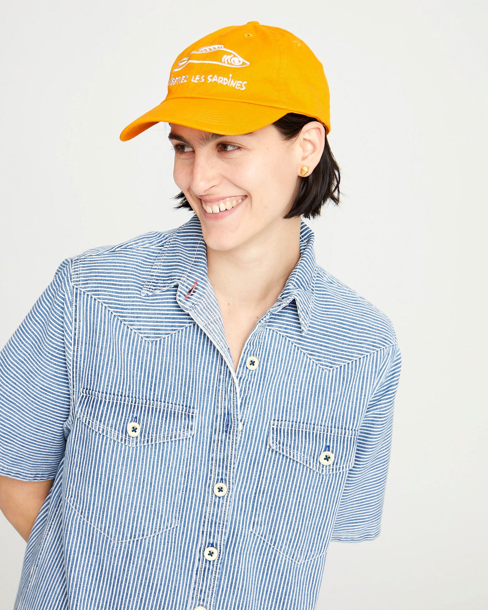 athena wearing the Marigold Liberez les Sardines Baseball Hat