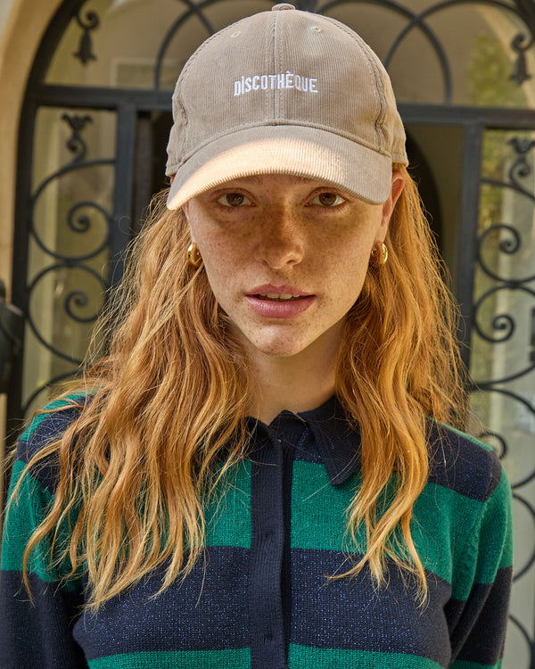 Haley wears the corduroy baseball cap in stone