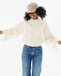 Mecca wearing the Stone Corduroy Discothèque Baseball Hat with the cream le drop fringe and jeans