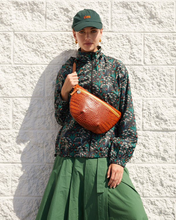 Lillian wearing the Forest Green Ciao Baseball Hat with the cuoio croco grande fanny across her chest
