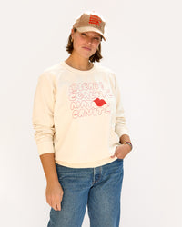Sonnie wearing the Tan Corduroy w/ Liberte Egalite Maternite Baseball Hat with the EMC Sweatshirt and jeans