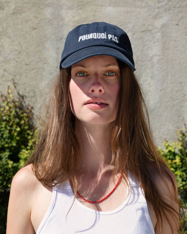 Gabrielle outside wearing the navy baseball hat with cream POURQUOI PAS