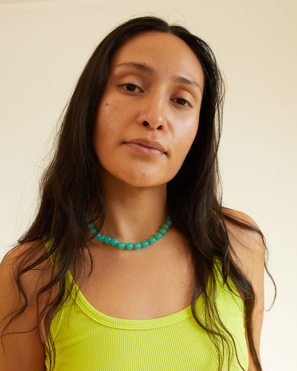 andrea with her hair down in a yellow tank top and the Aqua Beaded Glass Strand Necklace
