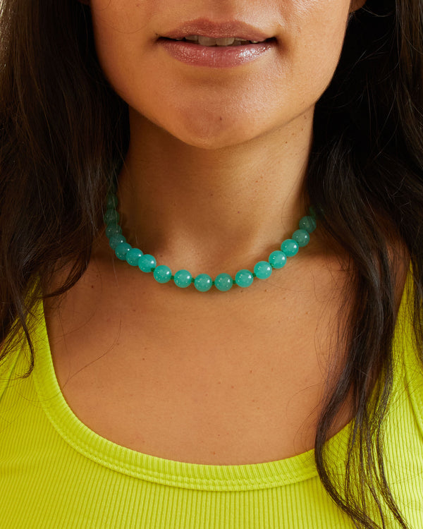 Andrea wearing the Aqua Beaded Glass Strand Necklace with a yellow tank top 