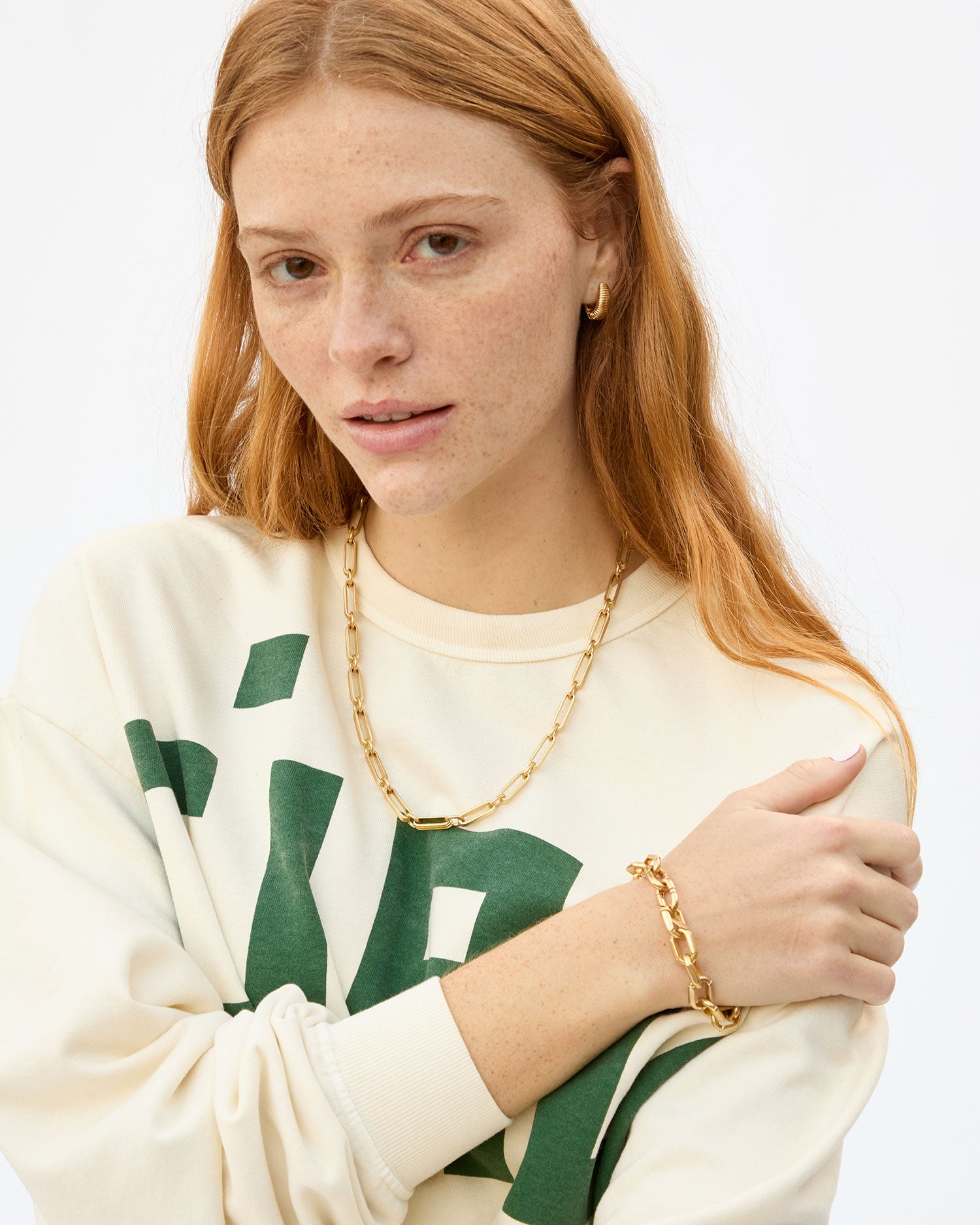 haley wearing the Vintage Gold Book Chain Necklace over the cream ciao oversized sweatshirt