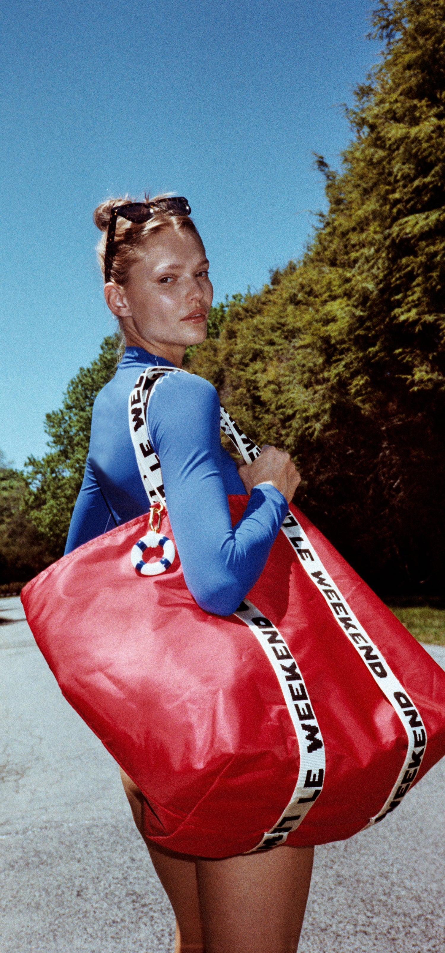 Model carrying the Clare V. x Left On Friday Giant Trop Avion. 