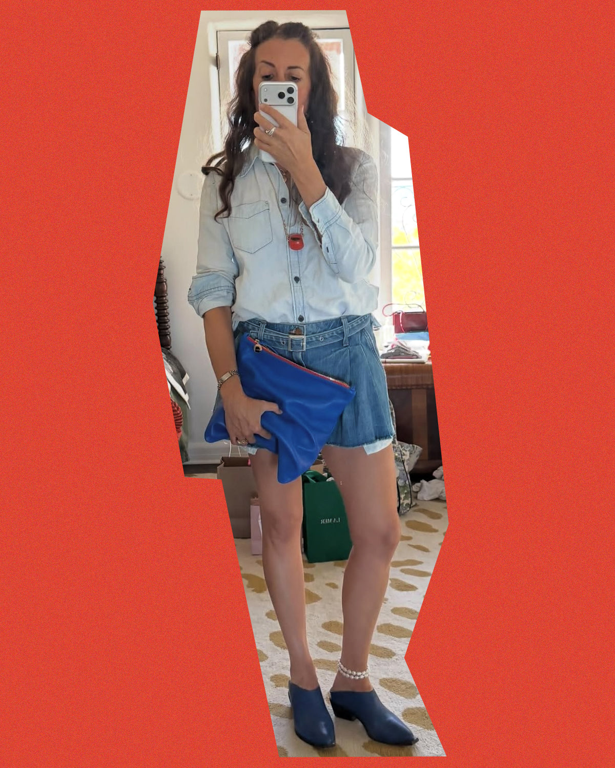 Clare holding the Electric Blue Foldover Clutch with Tabs.