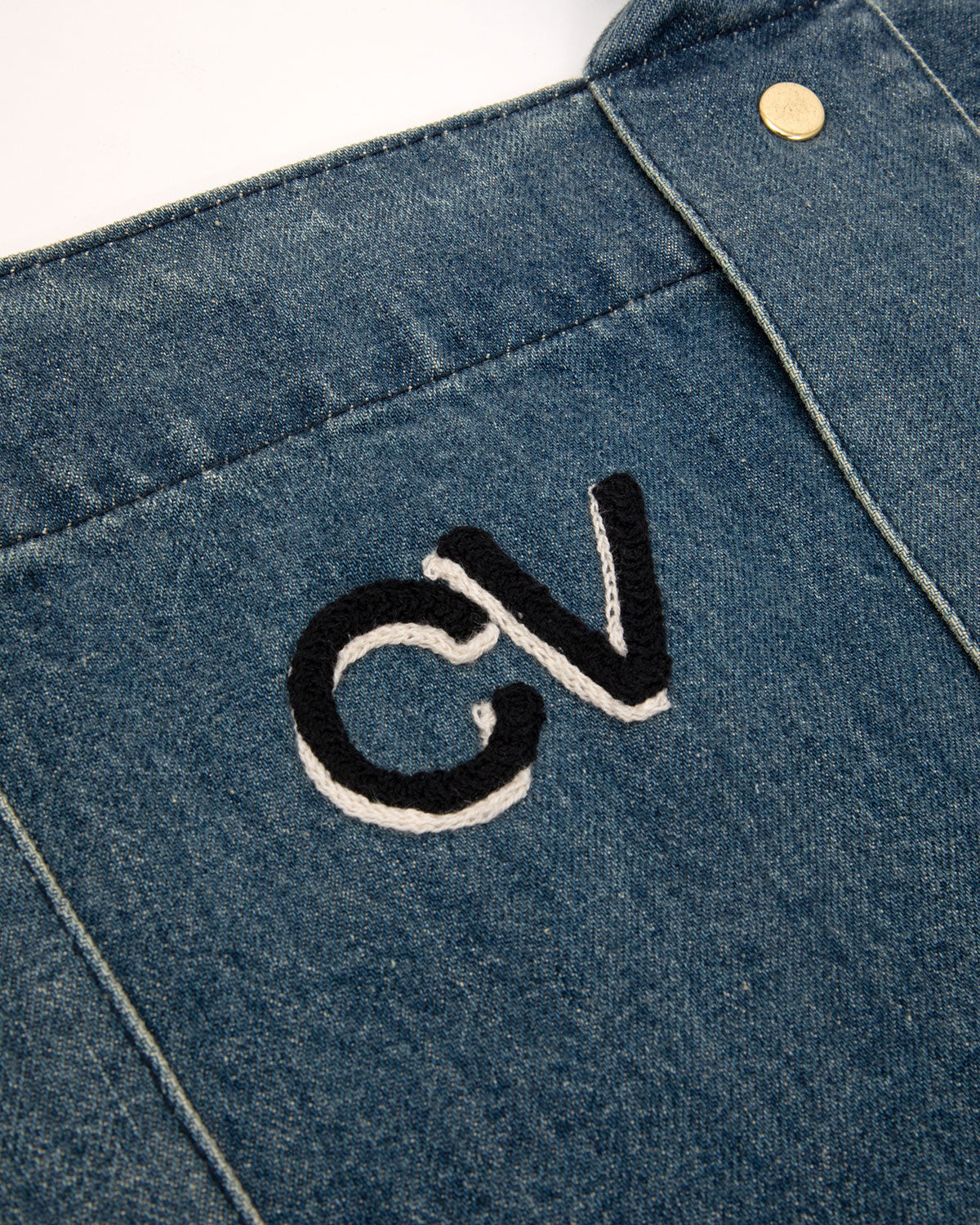 Close-up of the Denim Giant Trope with Block with Shadow embroidery. 