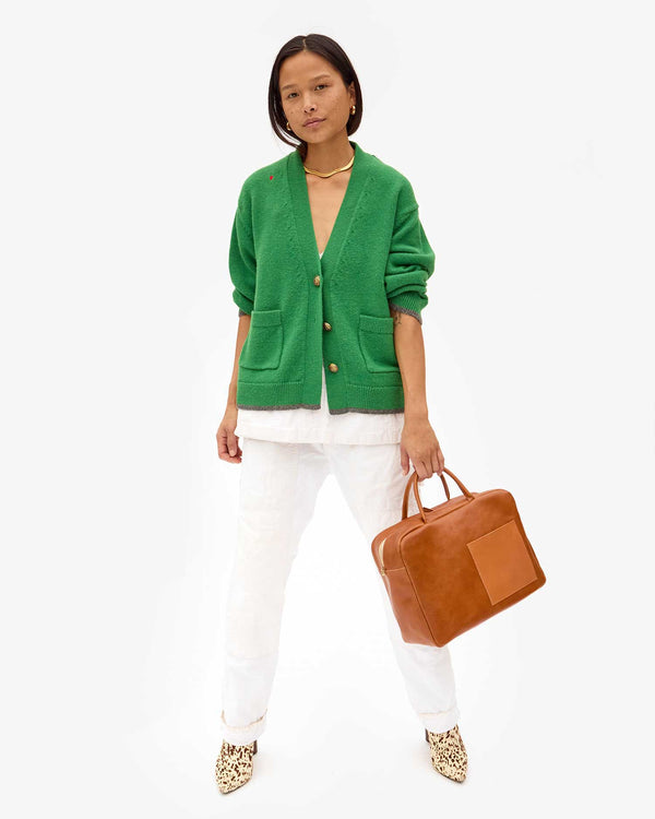 maly wearing the Oscar Sweater in Granny Smith. she's holding the miel claude