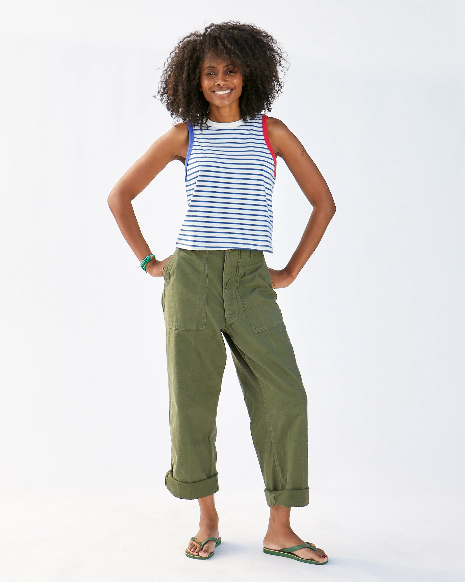 Mecca wearing the Cobalt and Cream Petit Stripe Camp Fit Tank with cargo pants and flip flops