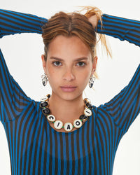 Aurelia wearing statement earrings and the Black Multi Ciao Collar
