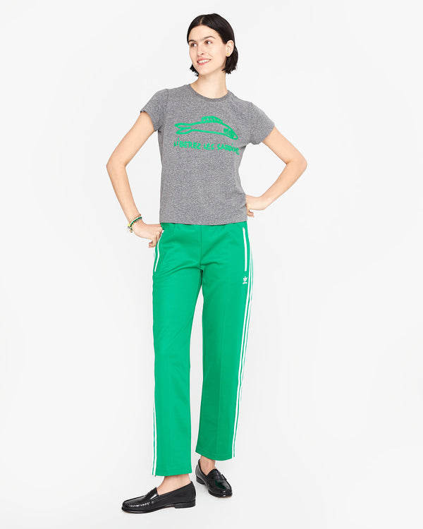 athena wearing green pants with the Grey Liberez les Sardines Classic Tee and black loafers