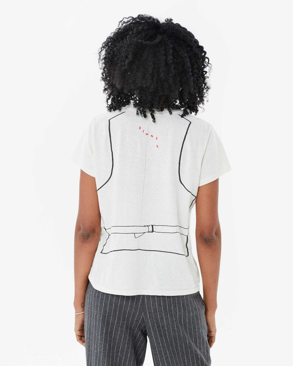 back view of mecca in the Cream Trompe l’oeil Vest Classic Tee. the tee is untucked to show the length of the shirt