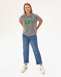 Sonnie with her hands on her hips in the Classic Tee in Grey Oui and jeans with sneakers 