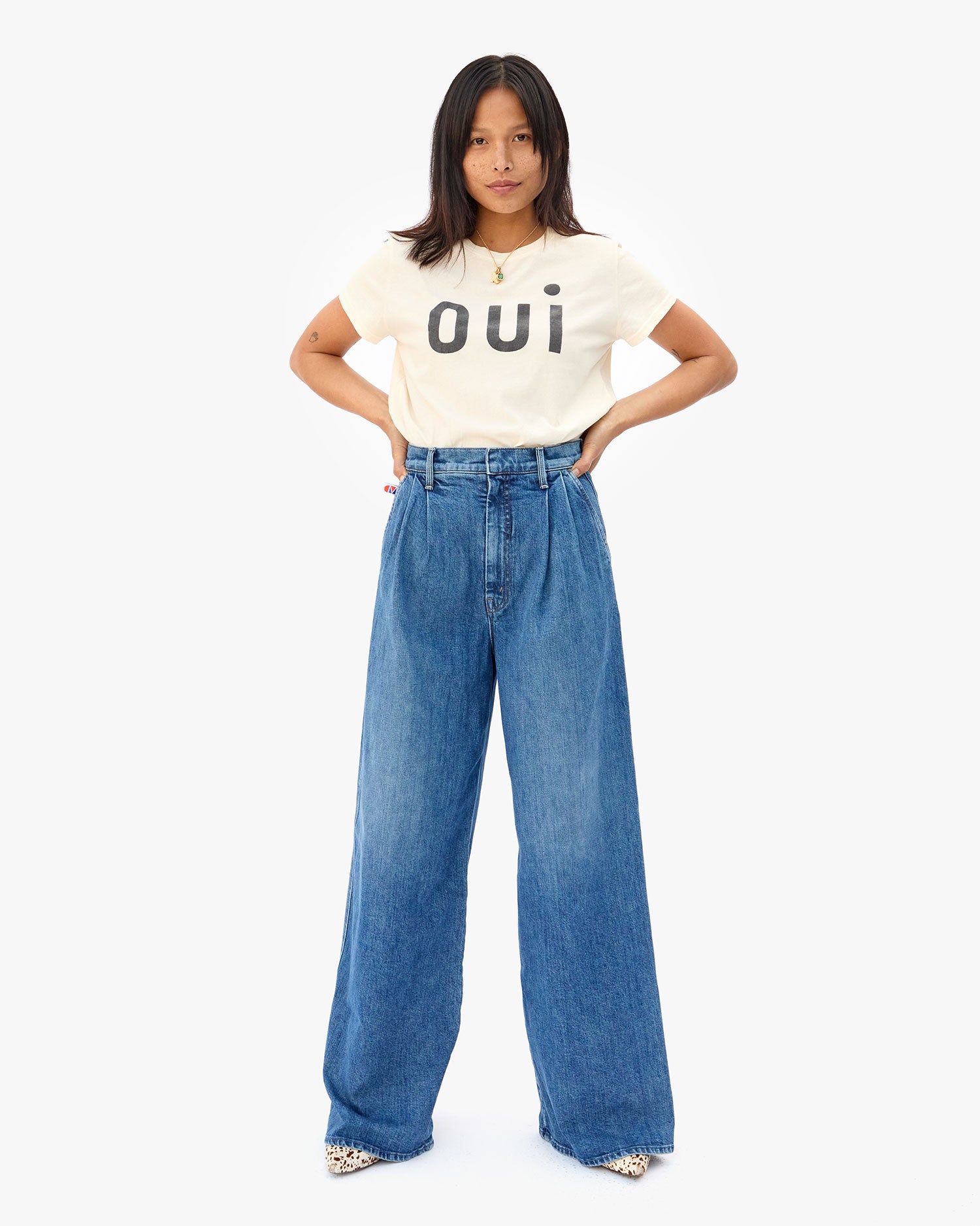 Maly with her hands on her hips in the Cream Oui Classic Tee and wide leg jeans