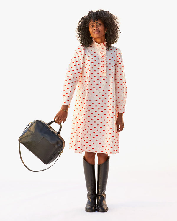 Mecca wearing the Eleanor Dress in Blush w/ Lips with tall riding boots