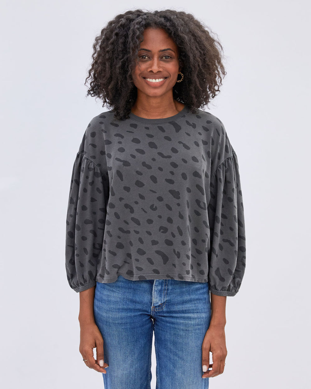 Mecca wearing our Faded Black with Jaguar Print Drop Shoulder Tee untucked with denim jeans.