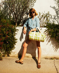 Lou carrying the Natural w/ Tennis Balls Duffle