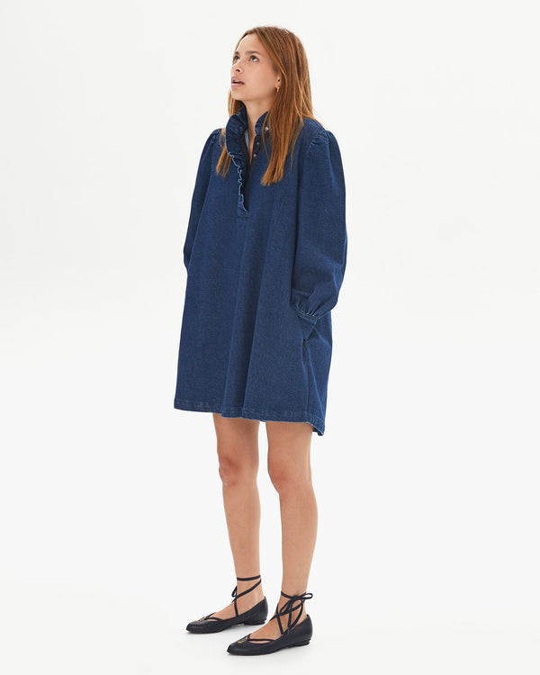 Aurelia wearing the Denim Twill Ella Dress with her hands in the pockets 