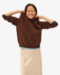 Maly holding the neckline of the Chocolate Elsa Sweater