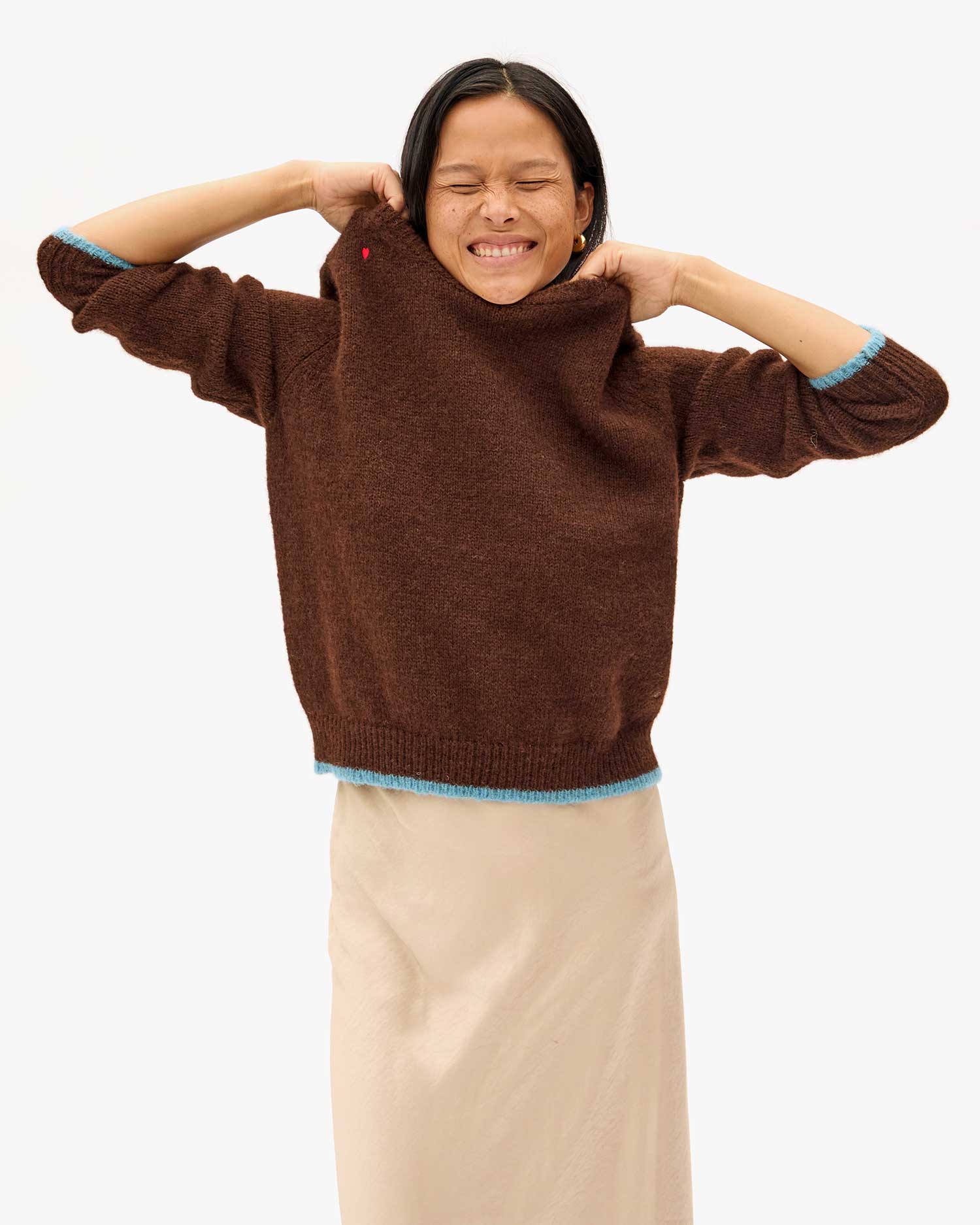 Maly holding the neckline of the Chocolate Elsa Sweater