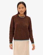 Maly wearing the Chocolate Elsa Sweater with a tan skirt