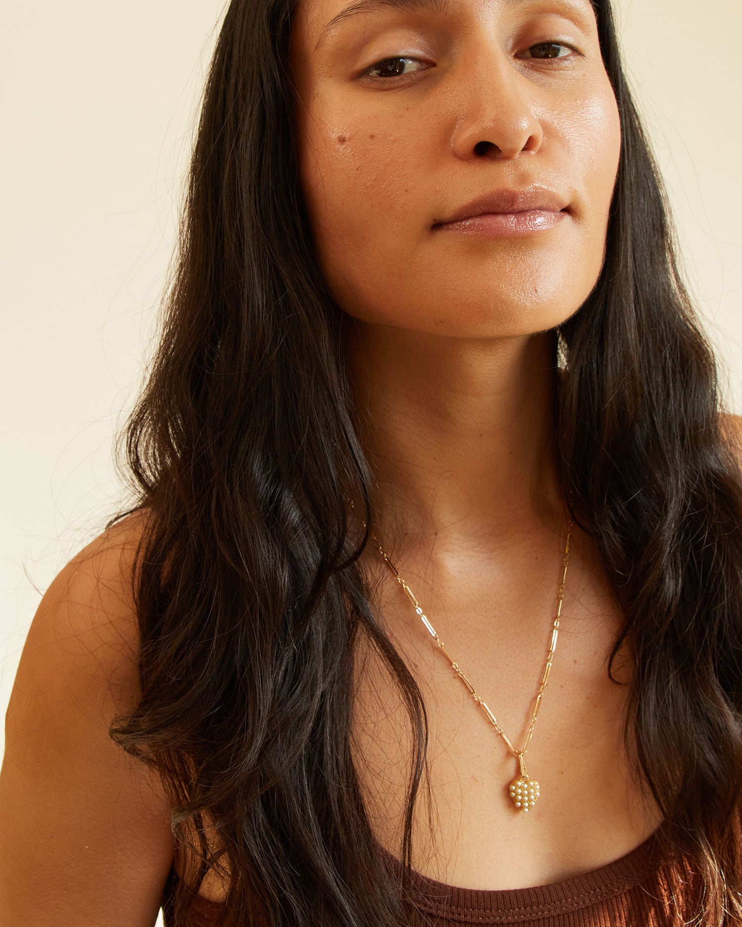 Andrea wears the encrusted pearl heart charm on the paperclip necklace