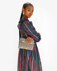 Jordan with her arms crossed and the Silver Beaded Fringe Estelle in one hand