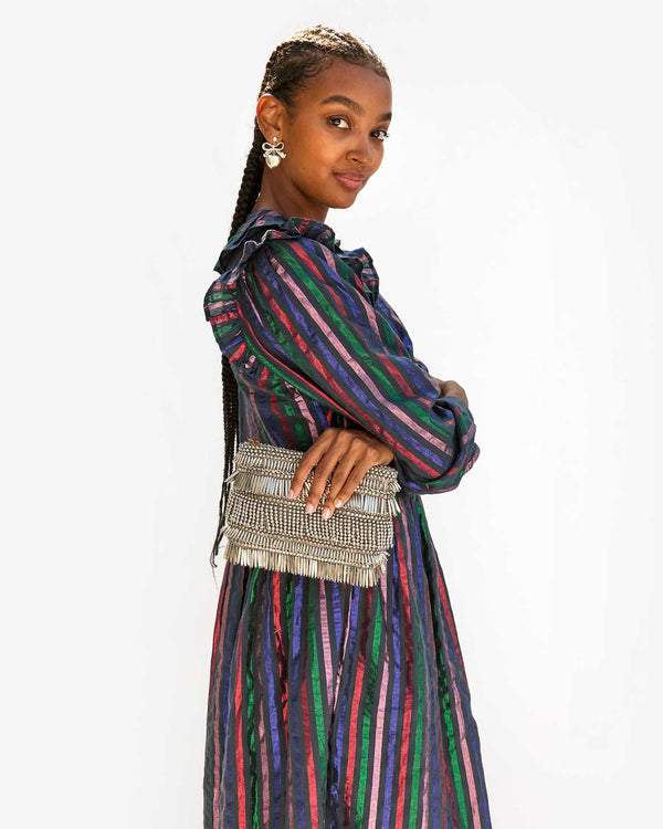 Jordan with her arms crossed and the Silver Beaded Fringe Estelle in one hand