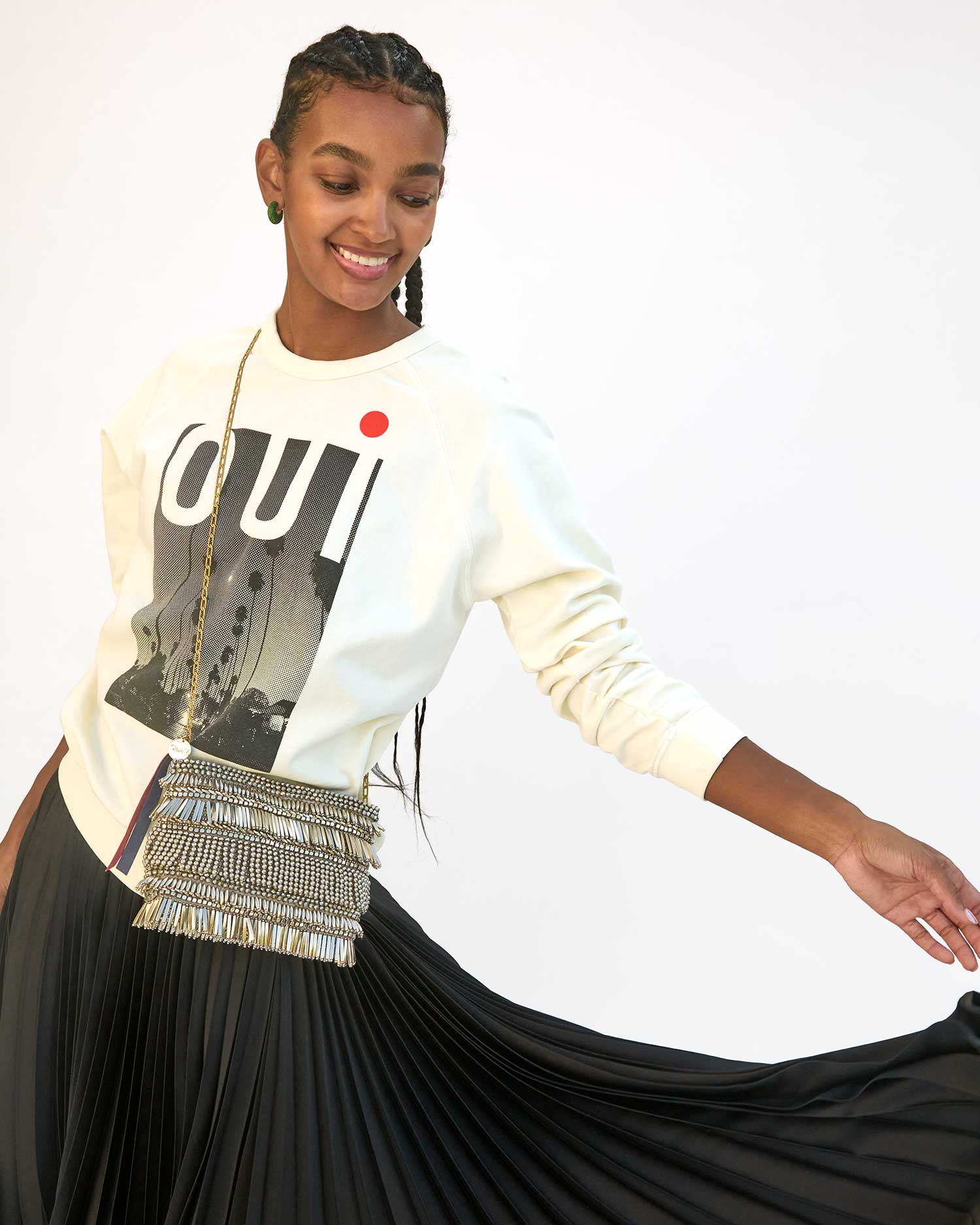 Jordan wearing the Silver Beaded Fringe Estelle crossbody over the Thierry Oui Sweatshirt and a black pleated skirt 