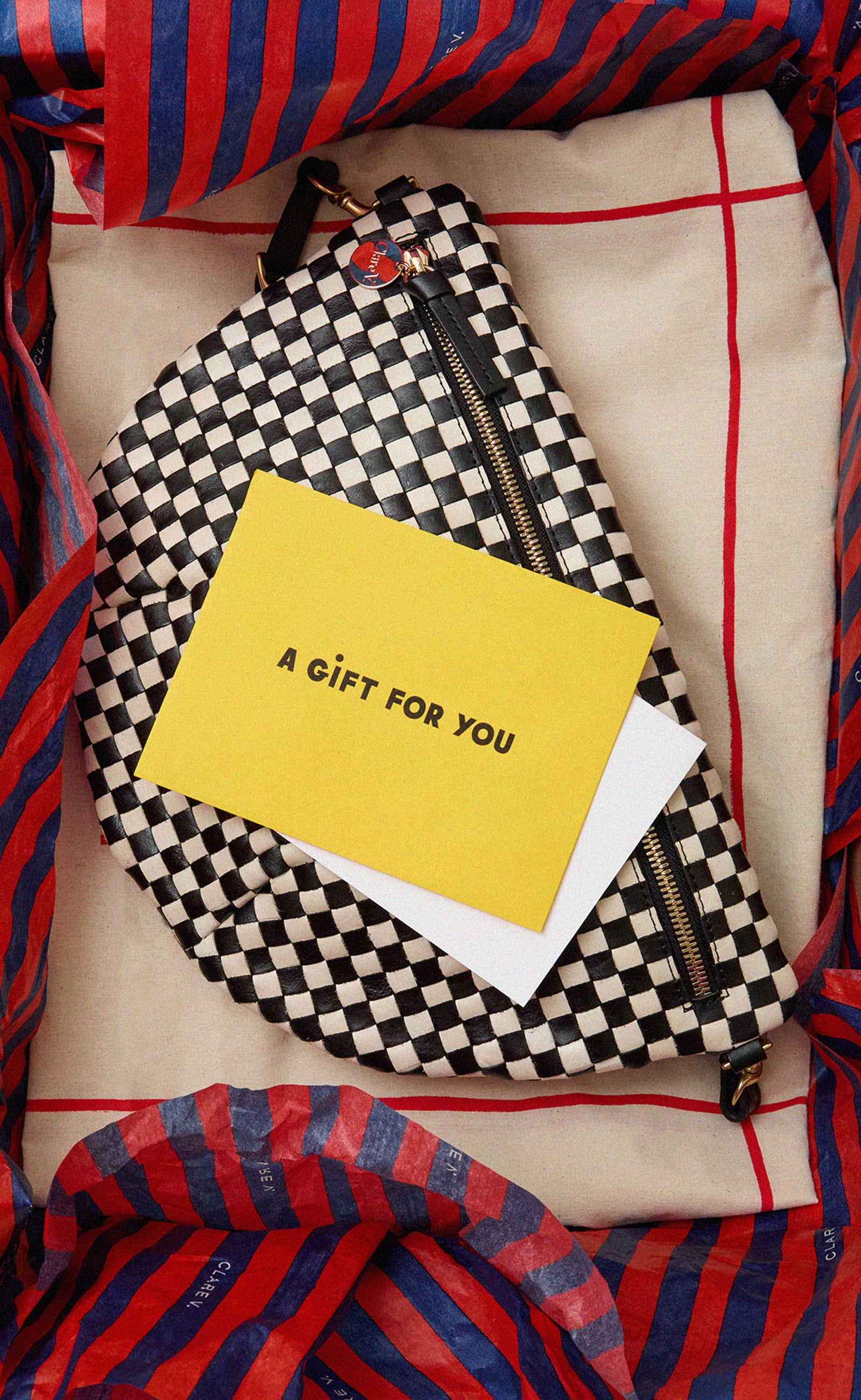 Black and Cream Woven Checker Grande Fanny in a gift box with a note that reads A Gift For You.
