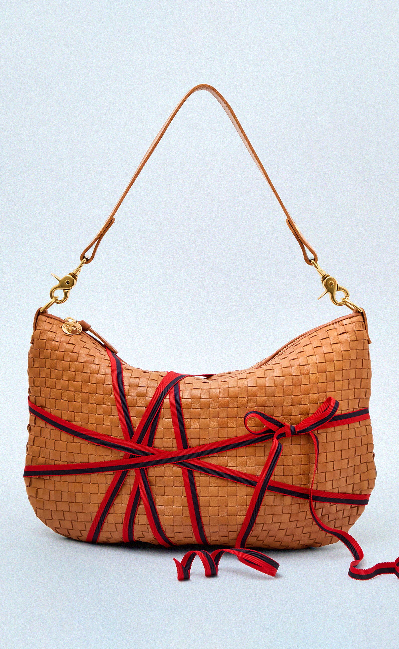 Natural Woven Checker Moyen Messenger with Ribbon tied around it to mark it as a gift. 