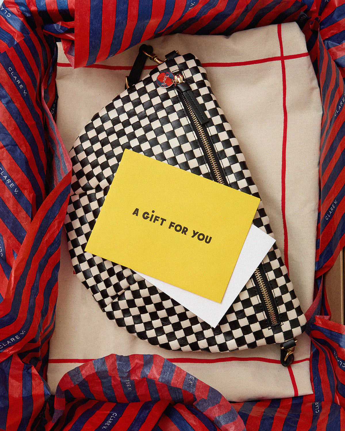 Black and Cream Woven Checker Grande Fanny in a gift box with a note that reads A Gift For You.