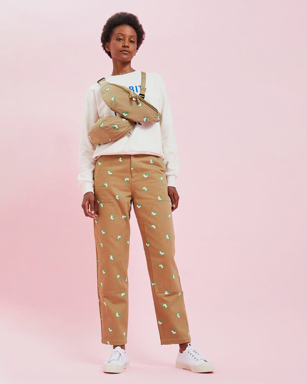 Model wearing the Khaki Cargo Pants with two khaki fanny packs worn across her chest