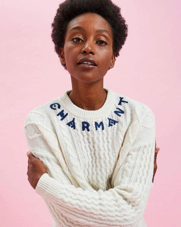 Model wearing the Cream w/ Navy Charmant Fisherman Sweater giving herself a hug