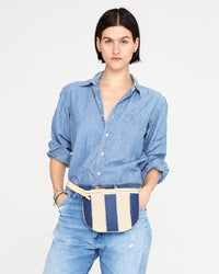 athena wearing the Indigo & Cream Woven Racing Stripes Fanny Pack around her waist over an all denim outfit