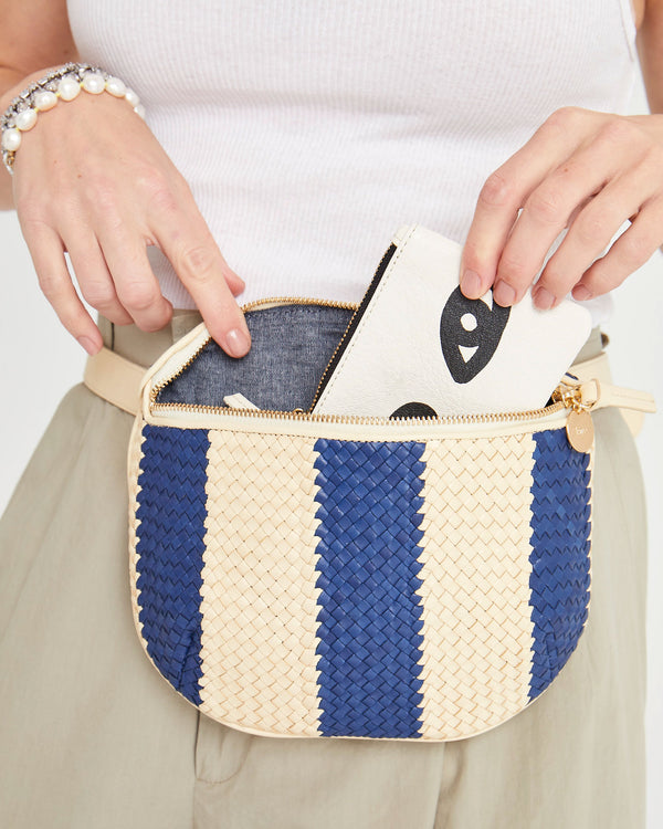 Danica pulls a coin clutch out of the Indigo and Cream Racing Stripes Fanny Pack