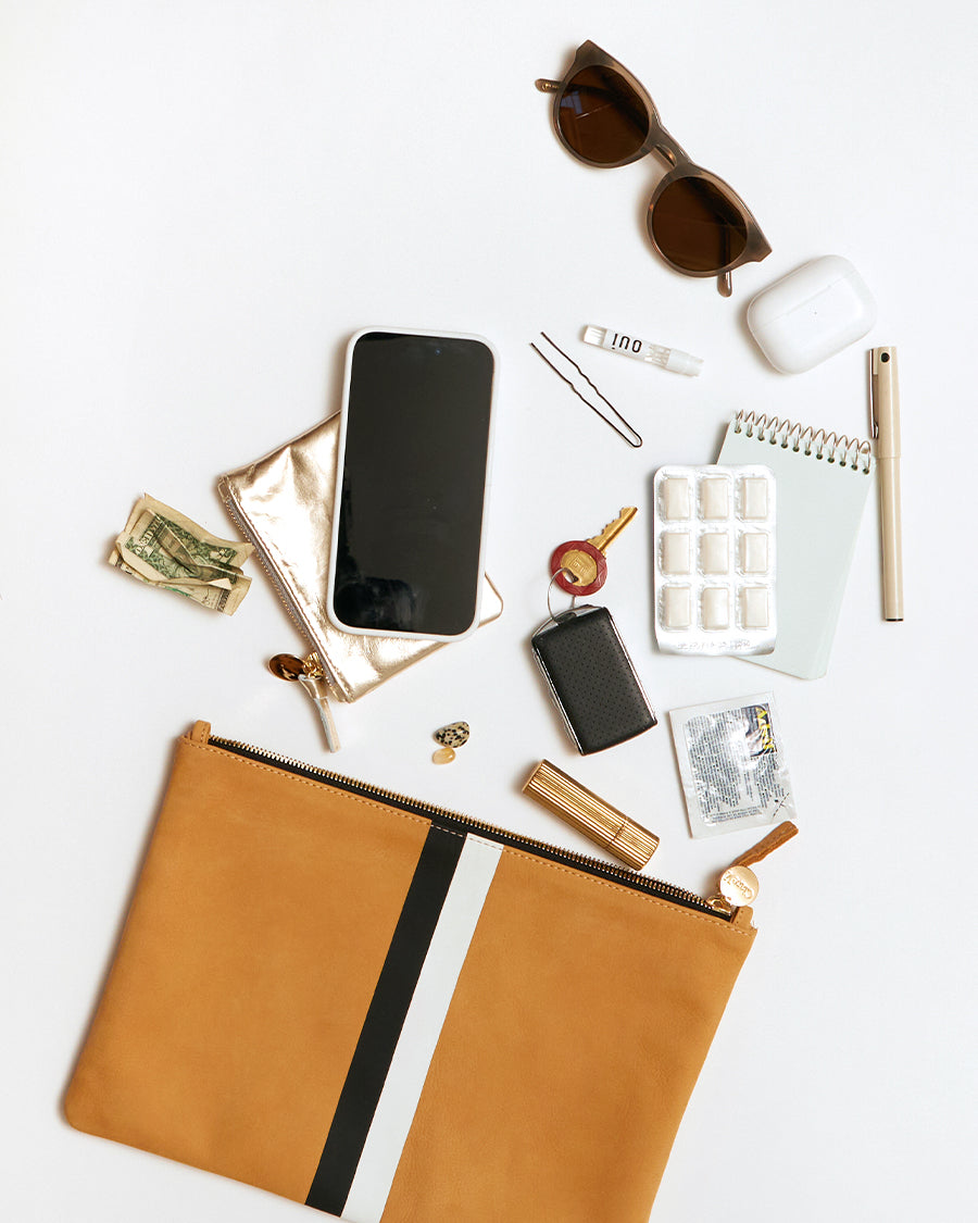 Flat clutch fits phone, keys, wallet, glasses, airpods, small notebook plus a few every day essentials