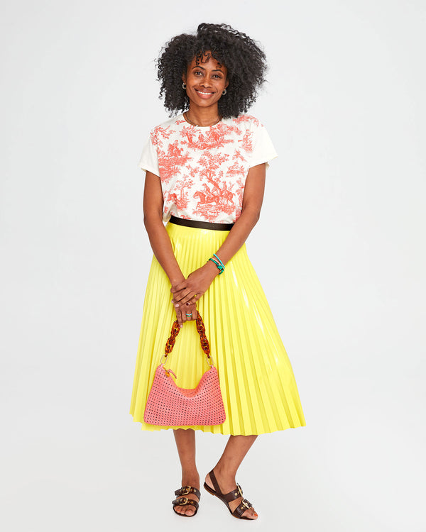 Mecca carrying the unlined Petal Rattan Flat Clutch with Tabs with our Tortoise Shortie Strap as a top handle bag.